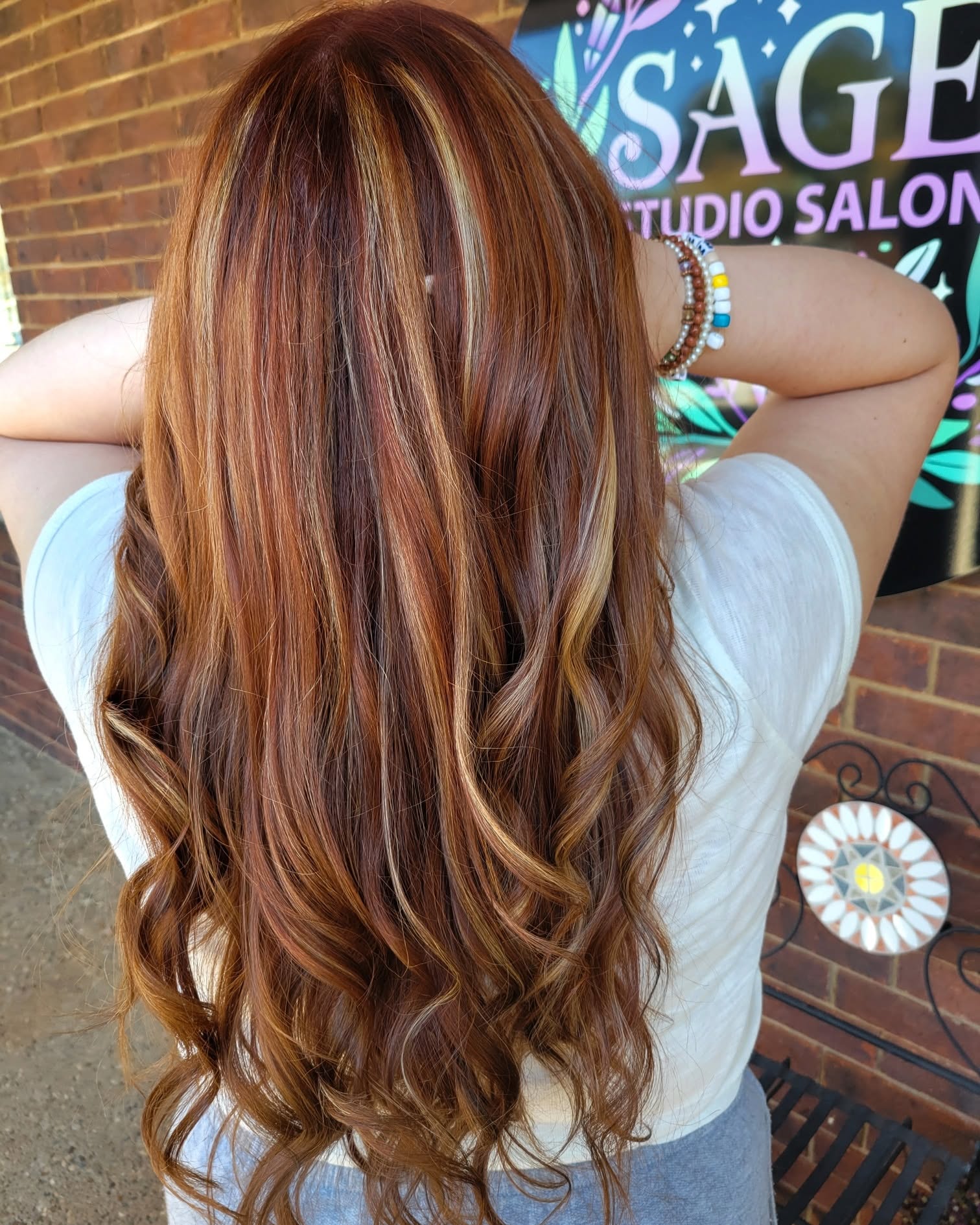 Long copper hair with dimensional highlights styled by Sienne Coonts