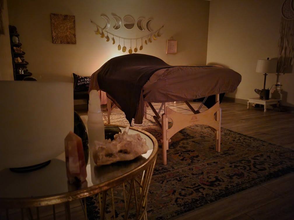 Warm, softly lit massage room at Sage Studio Salon