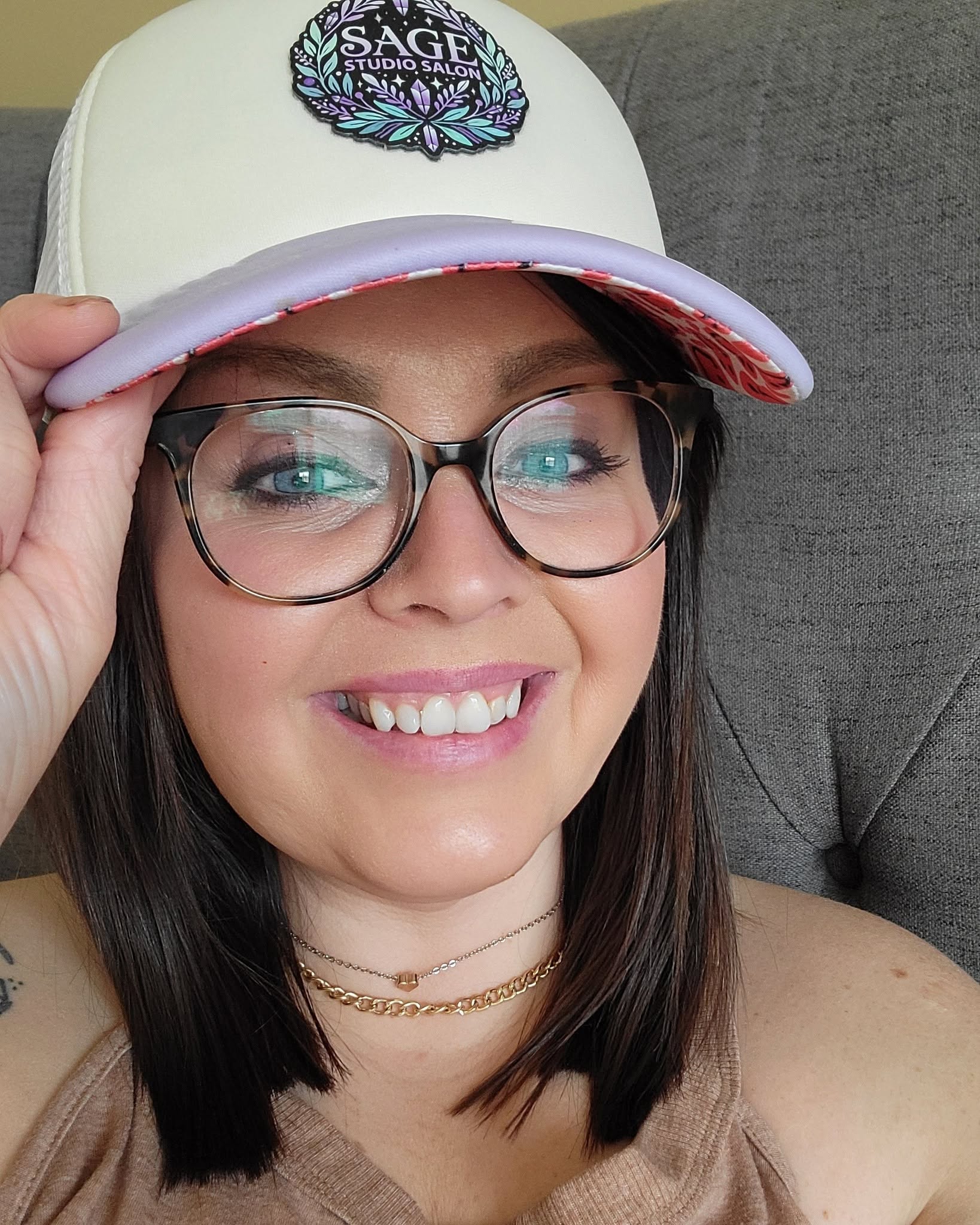 Sieanne Coonts, founder of Sage Studio Salon, wearing a Sage logo cap